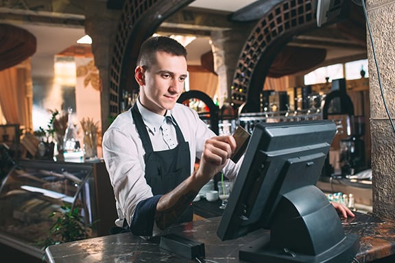 a-server-swipes-a-card-in-a-pos-system