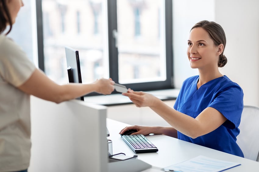 medicine, people and healthcare concept - happy smiling female doctor or nurse and patient with insurance or credit card card at hospital
