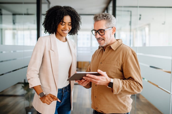 black-woman-and-white-guy-looking-at-ipad