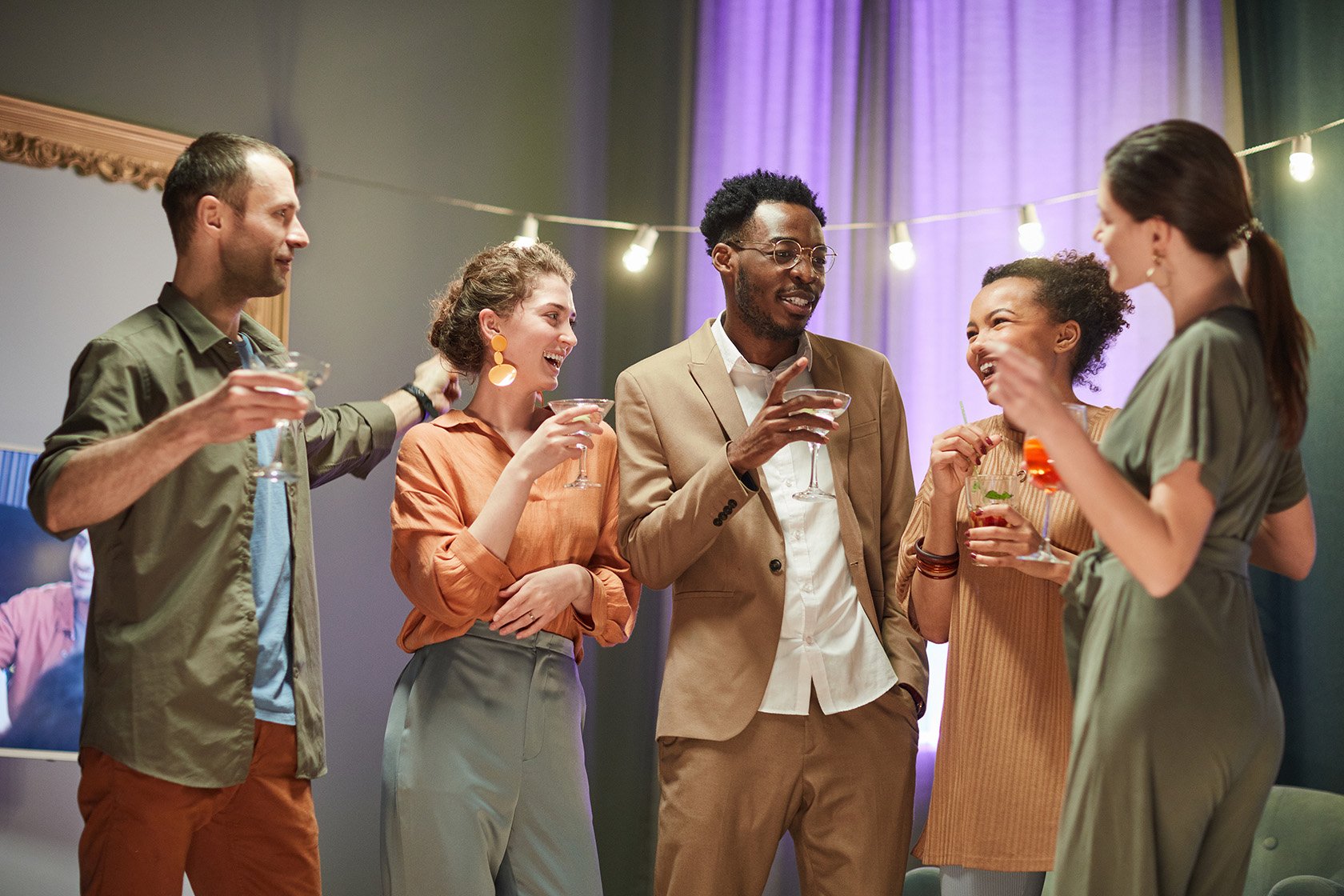 a group of coworkers having a good time at an office holiday party.