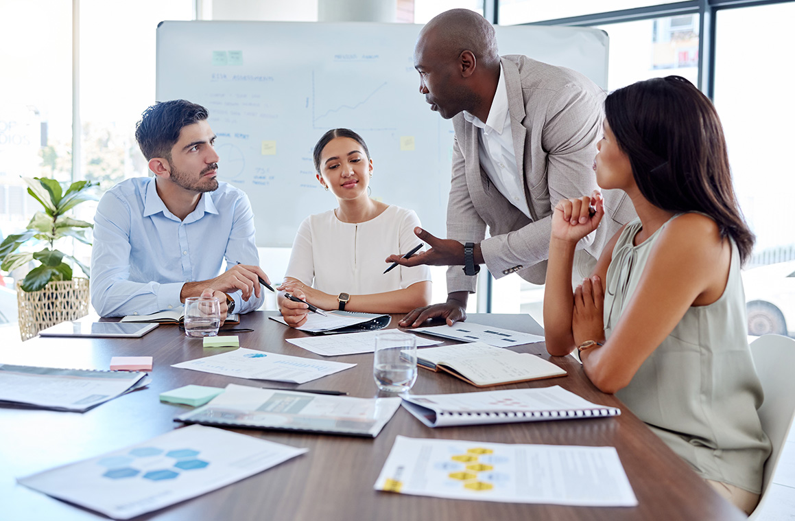 a group of corporate workers talking about growing their business.