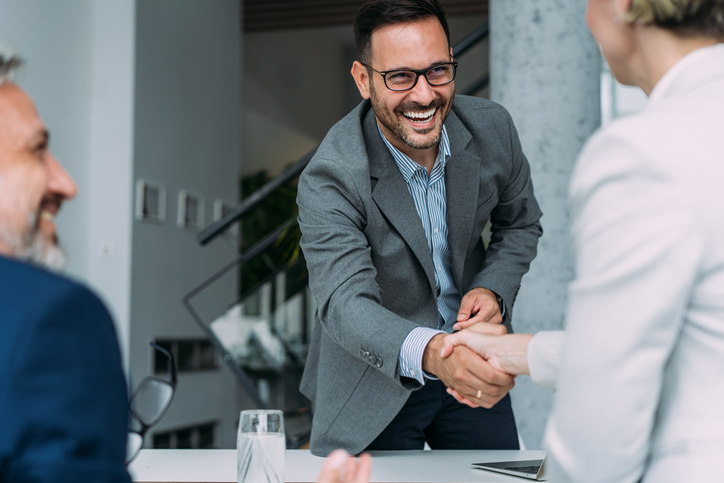 a man shaking a woman's hand